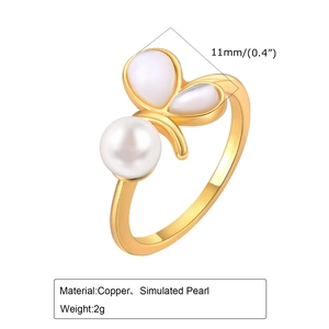 Detail view of adjustable gold butterfly ring with pearl and shell texture wing design