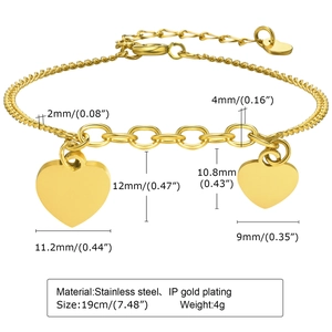 Gold double heart pendant stainless steel bracelet with oval link chain on white background