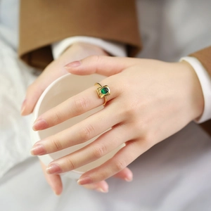 Golden geometric ring for women featuring an emerald green oval zircon stone inlay