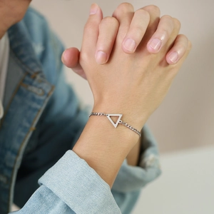 Minimalist stainless steel geometric triangle NK chain bracelet worn on female wrist