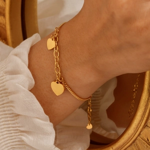 Gold stainless steel bracelet with three heart charms and elegant mixed-link chain style