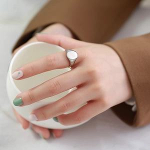 Polished stainless steel oval signet ring for women worn on finger for a minimalist look
