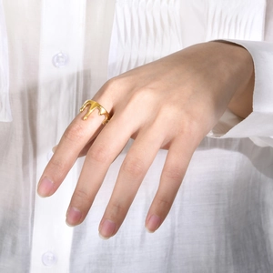 Detailed view of a gold liquid lava ring with smooth polished finish on model hand