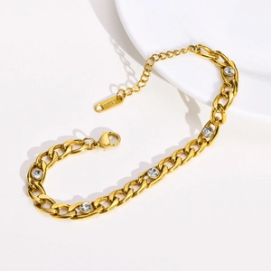 Detail of gold stainless steel NK chain bracelet with clear zircon stones and lobster clasp