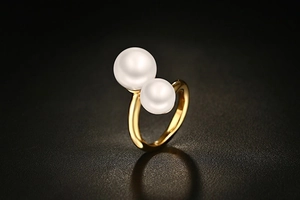 Detail of dual pearls on a gold-plated open ring with a 3mm polished metallic band