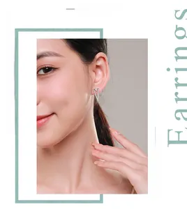 Detail of silver S925 triangle earrings with cubic zirconia on a female model