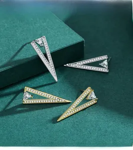 Detailed view of S925 silver and gold triangle stud earrings with sparkling pavé crystals