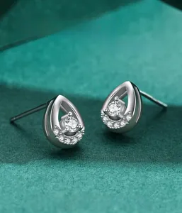 Macro view of teardrop silver earrings with hollow design and bright center zircon stone