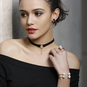Detail of elegant gold jewelry set with pearls including necklace earrings and ring