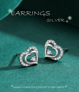 Macro detail of S925 sterling silver heart stud earrings with sparkling cubic zirconia
