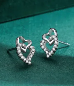 Macro detail of S925 silver interlocking heart earrings with sparkling cubic zirconia