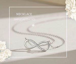 Macro detail of silver infinity pendant necklace featuring sparkling white zircon accents