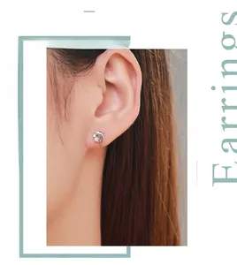 Gros plan de boucles d'oreilles dauphin en argent S925 avec zircons sur un modèle