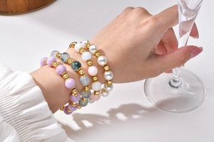 Detail of four-piece layered beaded bracelet set with natural stones and pearls