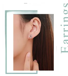 Close-up of S925 silver double heart earrings with micro-inlaid zircon on a model