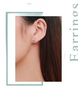 Detail of s925 silver star earring with micro-pave cubic zirconia on a model's ear