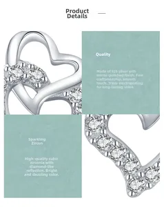 Macro view of s925 silver heart earring with cubic zirconia and polished mirror finish