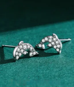Macro shot of S925 sterling silver dolphin stud earrings with cubic zirconia pavé