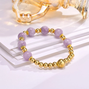 Detail of lavender stone beads and gold metal spacers on a handmade bracelet