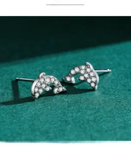 Macro detail of S925 sterling silver dolphin studs with sparkling cubic zirconia inlay