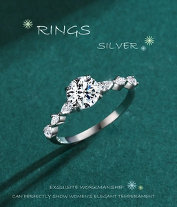 Macro detail of S925 silver ring featuring round center diamond and pear-shaped side stones