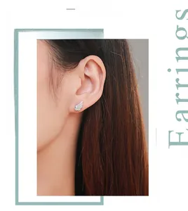 Close-up of S925 sterling silver angel wing earrings with micro-paved zircons on model