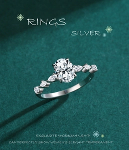 Macro view of oval cubic zirconia ring with silver band and side stone accents