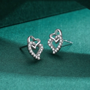 S925 sterling silver heart earrings with micro-inlaid zircon on dark green background