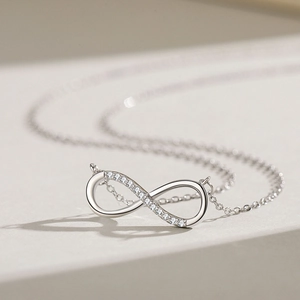 Elegant S925 sterling silver infinity pendant necklace with sparkling clear crystals