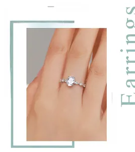 Close-up of S925 silver oval faux diamond ring with wavy pavé band on model's finger