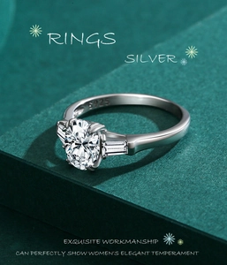 Close-up of S925 hallmark on silver ring with oval cut gemstone and side baguettes