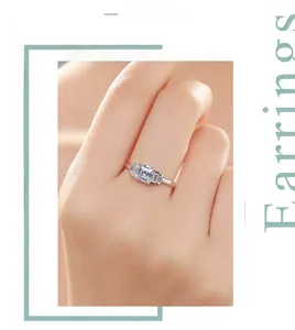 Close-up of S925 silver ring featuring a rectangular step-cut central diamond on finger