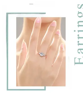 Close-up of three-stone sterling silver ring with oval cut center diamond on finger