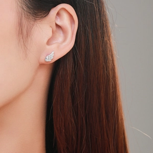 Elegant S925 sterling silver angel wing earrings with cubic zirconia on a female model