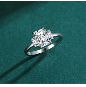 Macro shot of silver three-stone ring with rectangle cut radiant simulated diamond