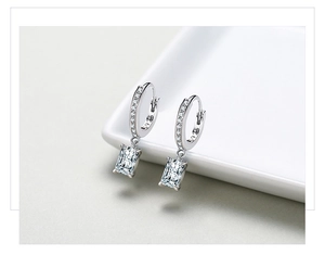 Macro detail of S925 hallmark on silver hoop earrings with rectangle cut cubic zirconia