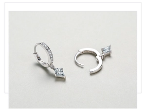 Macro detail of S925 sterling silver hoop earrings with rhombus cut cubic zirconia stone