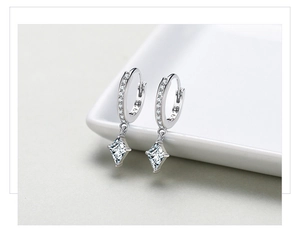 Macro shot of S925 sterling silver stamp and sparkling rhombus zircon earrings