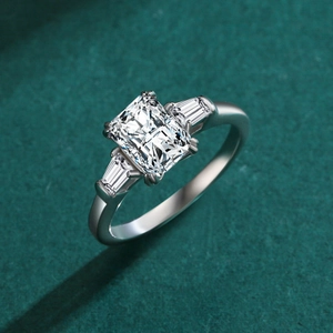 S925 sterling silver ring with emerald cut diamond on deep green background