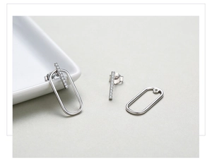 Detail of S925 silver geometric stud earrings with pave zircon and versatile drop design