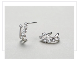 Close-up of S925 sterling silver curved earrings with gradient round white zircon stones