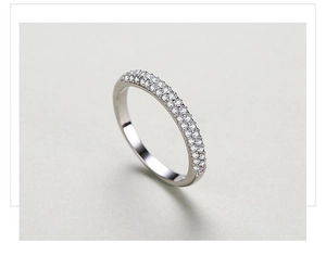 Detailed macro shot of a triple-row pavé diamond silver ring with polished finish