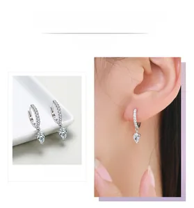 Macro detail of S925 sterling silver teardrop earrings with pear-cut cubic zirconia stones
