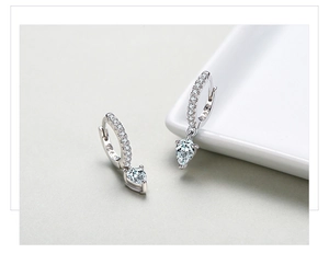 Macro detail of S925 sterling silver stamp and pear-cut teardrop earrings with zircons