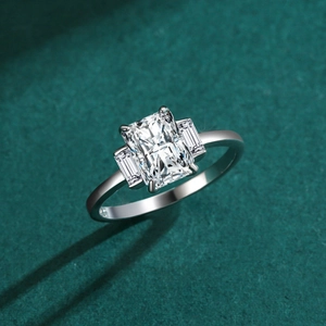 Three-stone S925 silver ring featuring a large emerald cut cubic zirconia center stone