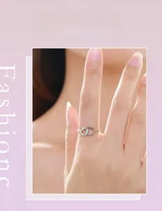 Detail of double heart s925 silver ring with pavé diamonds on a model's finger
