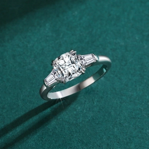 Classic S925 sterling silver cushion cut 1 carat three-stone engagement ring on green texture