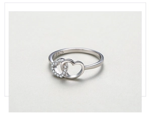 Macro shot of S925 sterling silver ring showing double heart design and sparkling zircon