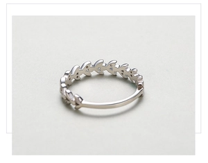 Macro shot of silver S925 leaf ring featuring delicate openwork and polished metal finish