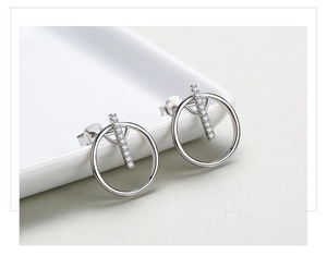 Macro detail of geometric S925 silver stud earrings with sparkling pave micro-zirconia